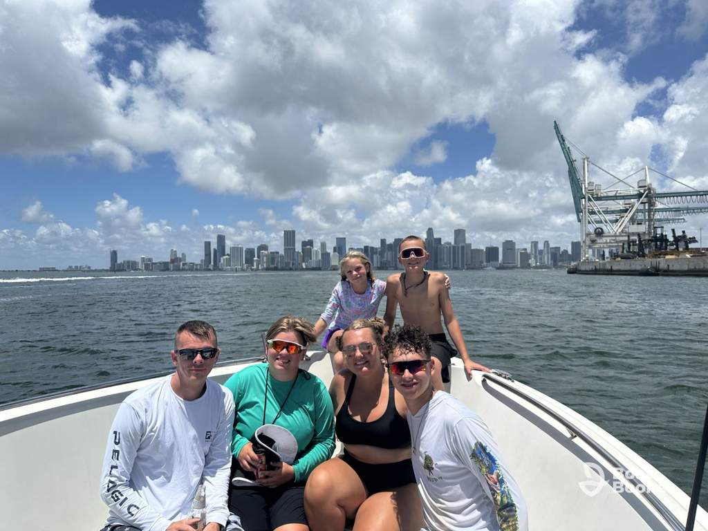 Center console boat cruising open water near Miami with passengers aboard