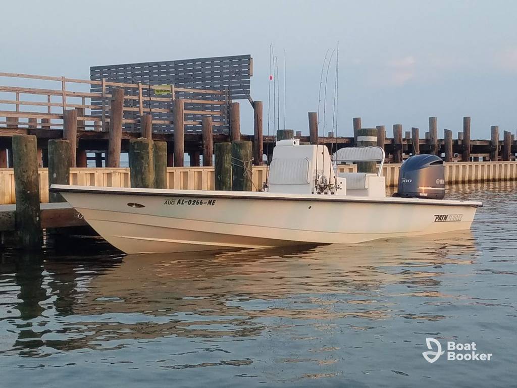 Pontoon boat cruising near Gulf Shores Alabama shoreline