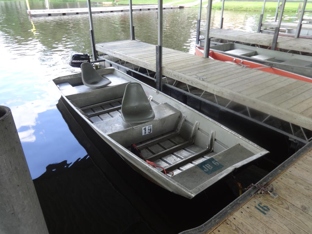 Aluminum jon boats with bench seats docked at Grassy Pond
