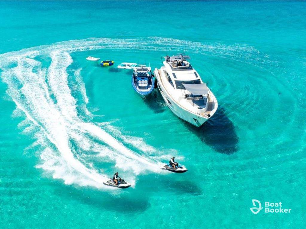 Luxury motor yacht cruising on open water with guests on deck