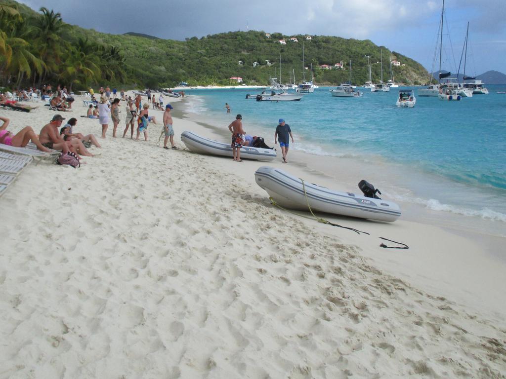 White Bay beach on Jost Van Dyke with people and dinghies ashore