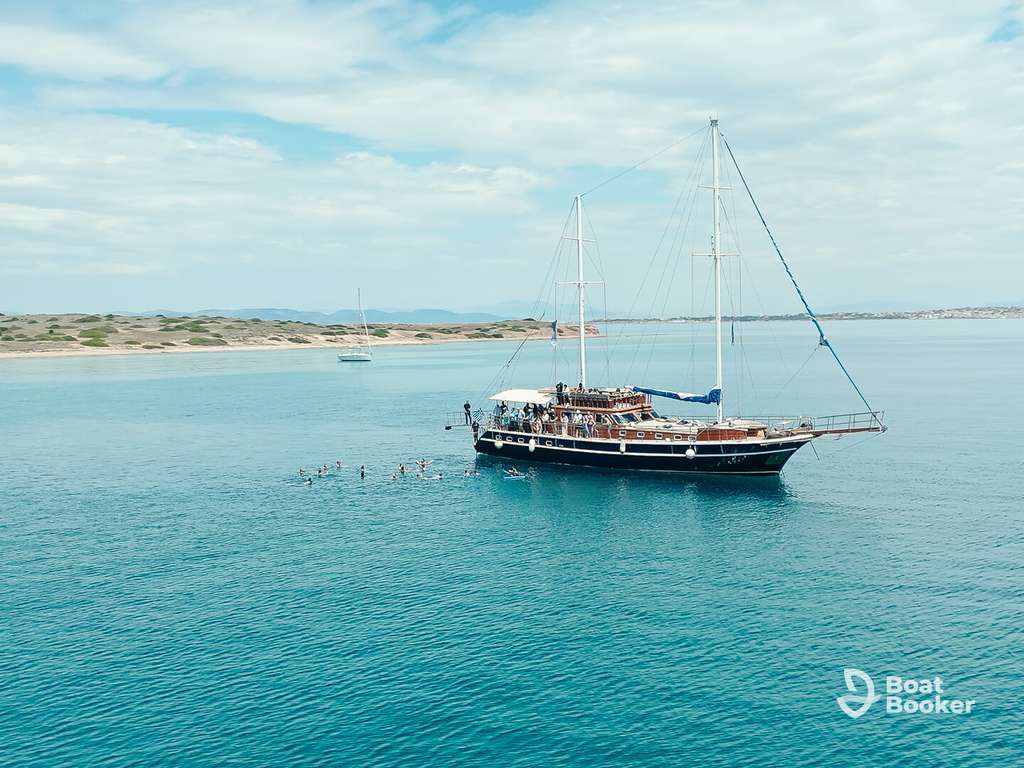 Group of passengers relaxing on a sailing yacht deck in Greece