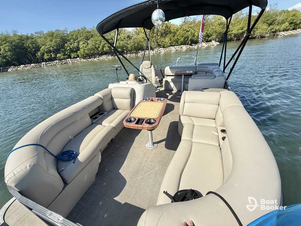 Pontoon boat cruising on the water with passengers aboard