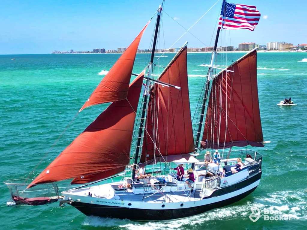 Sailboat with visible mast boom and rigging on calm coastal waters